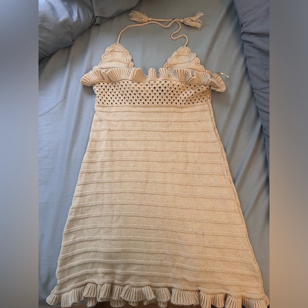 Small tan dress with tie top with cut out detail.